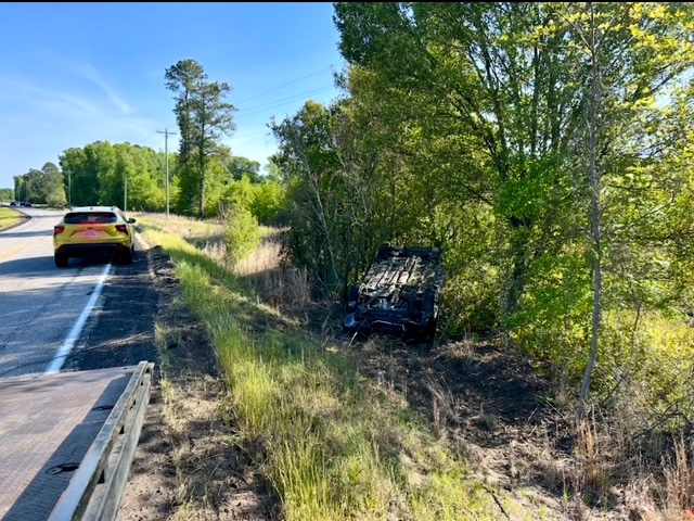 A vehicle that left the road and landed upside down in the trees beside it